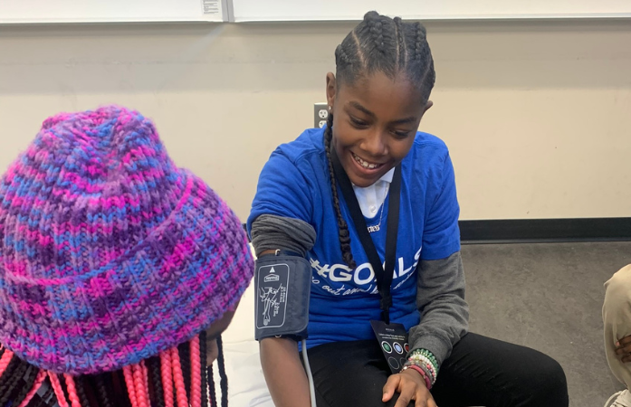  student taking another students blood pressure